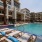 pool with reclining seats and lush landscaping